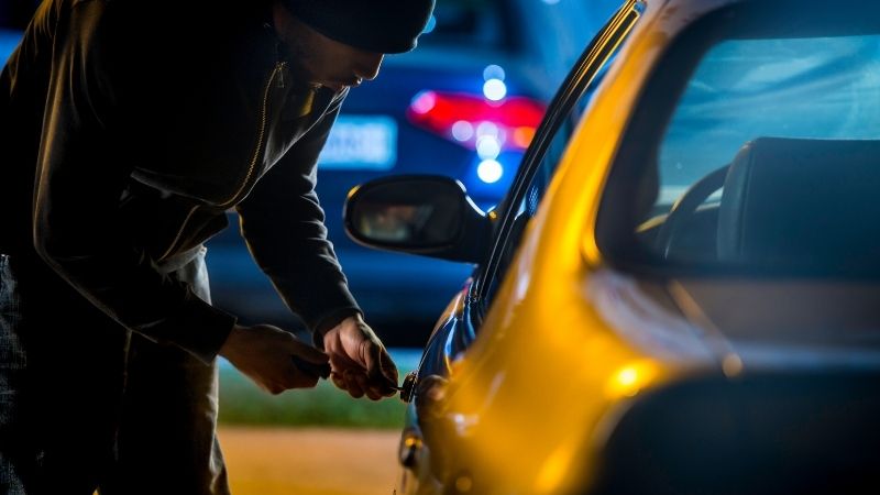 Thief breaking into car